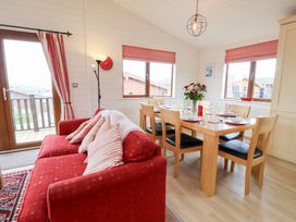 A dining room with a table and chairs at Ocean Terrace 28 Ilfracombe
