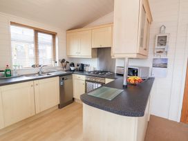 A kitchen with appliances and sink at Ocean Terrace 28 in Ilfracombe