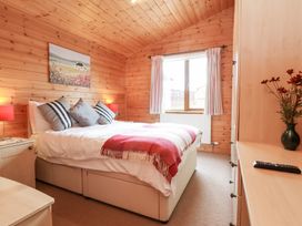 A bedroom with a bed and nightstand at Ocean Terrace 28 Ilfracombe