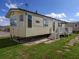 A caravan with steps at Hideaway Lodge in Abergele