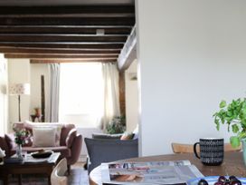 A living room with a table and mug at The Old Post Box in 