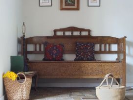An entryway with a bench and cushions at The Old Post Box in 