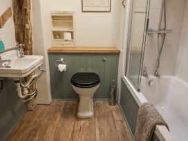 A bathroom with a sink, toilet, and shower at The Old Post Box in Halesworth