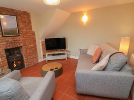 A living room with a sofa and television at 6 Gravel Hill in King's Lynn