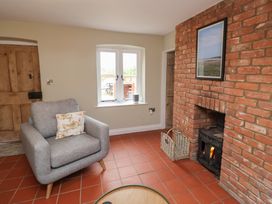 A living room with a sofa and fireplace at 6 Gravel Hill in King's Lynn