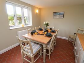 A dining room with a table set for breakfast at 6 Gravel Hill in King's Lynn