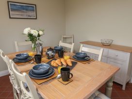 A dining room with a table set for breakfast at 6 Gravel Hill in King's Lynn