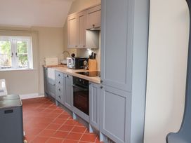 A kitchen with gray cabinets and appliances at 6 Gravel Hill in King's Lynn