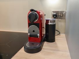 An espresso machine and milk frother on a countertop at 6 Gravel Hill in King's Lynn
