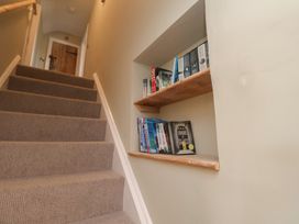 A staircase with a bookshelf displaying books at 6 Gravel Hill, King's Lynn