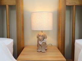 A lamp on a nightstand beside a bed at 6 Gravel Hill in King's Lynn