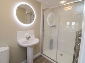 A bathroom with a sink, toilet, and shower at 6 Gravel Hill in King's Lynn