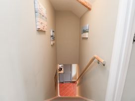 A staircase with a handrail and paintings on the wall at 6 Gravel Hill in King's Lynn