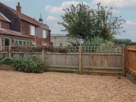 A garden area with gravel and a wooden fence at 6 Gravel Hill in King's Lynn