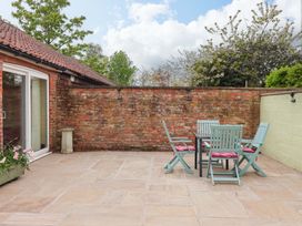 An outdoor space with a table and chairs at The Owl Barn Cottage
