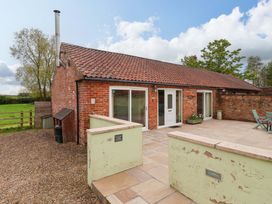 An outdoor patio area of a house with a garden at The Owl Barn Cottage