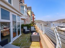 An outdoor area with seating and water view at 26 Dart Marina