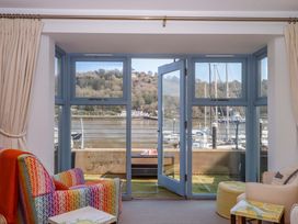 A living room with open doors and seats at 26 Dart Marina