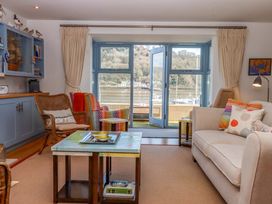 A living room with a sofa and coffee table at 26 Dart Marina