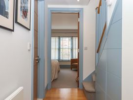 A hallway with stairs and a door leading to another room at 26 Dart Marina