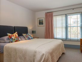 A bedroom with a bed and window at 26 Dart Marina