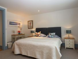 A bedroom with a bed and decorative pillows at 26 Dart Marina