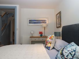 A bedroom with a bed, side table, and lamp at 26 Dart Marina