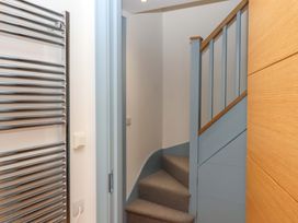 A staircase with a towel radiator at 26 Dart Marina