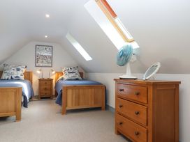 A bedroom with two beds and a nightstand at 26 Dart Marina