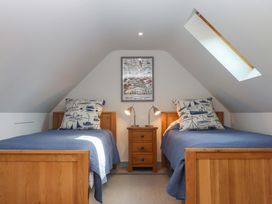 A bedroom with two beds and a bedside table at 26 Dart Marina