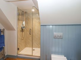 A bathroom with a shower and toilet at 26 Dart Marina