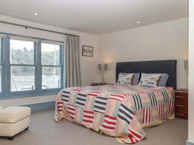 A bedroom with a bed and nightstands at 26 Dart Marina