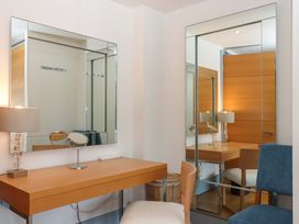 A dressing room with a vanity table and mirrors at 26 Dart Marina