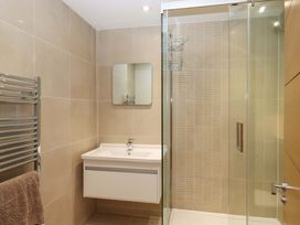 A bathroom with a sink and shower at 26 Dart Marina