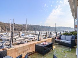An outdoor patio with boats at a marina at 26 Dart Marina