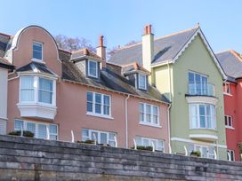 A row of houses with balconies and windows at 26 Dart Marina