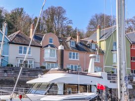 Houses by the dock with a boat in front at 26 Dart Marina