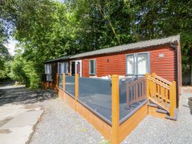 An outdoor view of a cabin with a deck at Feather Hill Lodge White Cross Bay near Troutbeck Bridge