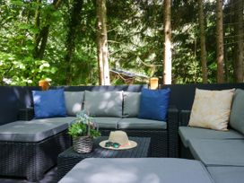 An outdoor seating area with a sofa and table at Feather Hill Lodge White Cross Bay, Skiptory Howe 38