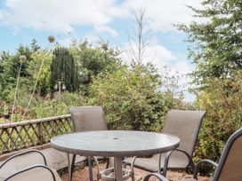 A garden with a table and chairs at Mayflower View, Dawlish