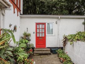 An entrance with a red door and plants at Mayflower View in Dawlish