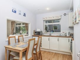 A kitchen with a table and chairs at Mayflower View in Dawlish