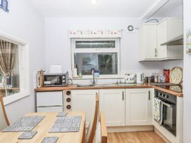 A kitchen with a table and chairs at Mayflower View in Dawlish
