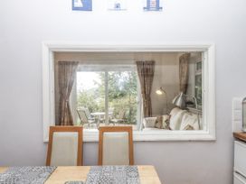 A dining room with a view of a living area at Mayflower View in Dawlish