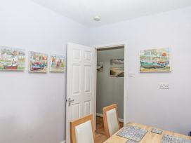 A dining room with a table and chairs at Mayflower View in Dawlish