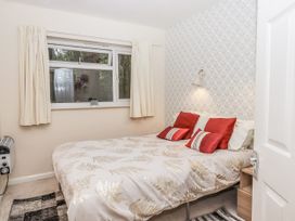 A bedroom with a bed and window at Mayflower View in Dawlish
