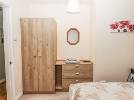 A bedroom with wardrobe and chest of drawers at Mayflower View in Dawlish