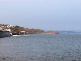 A beach landscape with cliffs and houses at Mayflower View in Dawlish