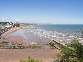 A beach with waves and a coastline at Mayflower View in Dawlish