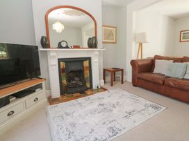 A living room with a television, fireplace, and sofa at Pedn Brose Near Mousehole